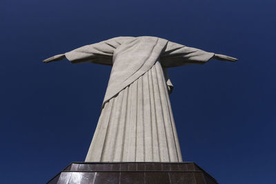 Low angle view of statue against blue sky