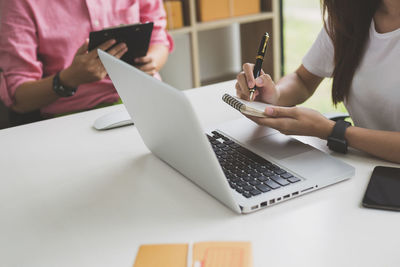 Midsection of woman using mobile phone