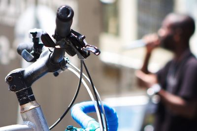 Close-up of hand holding bicycle