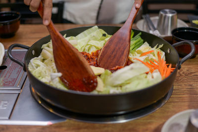 Close-up of hand holding food on table