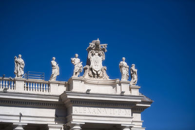 Low angle view of statue against blue sky