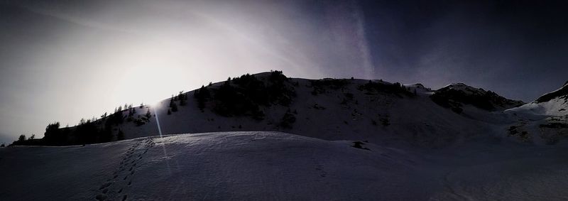 Panoramic view of snowcapped mountains against sky