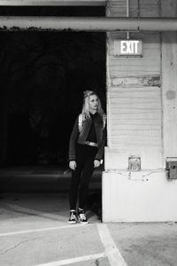 Full length of woman leaning on wall