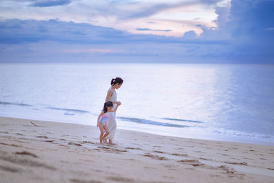 Full length of boy on beach against sky