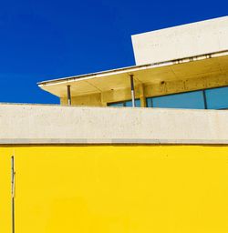 Low angle view of building against blue sky