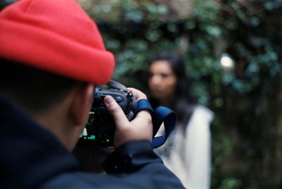 Men taking photo of women