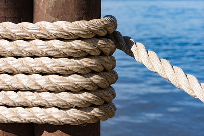 Close-up of rope tied up against sky