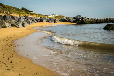 Scenic view of beach against clear sky