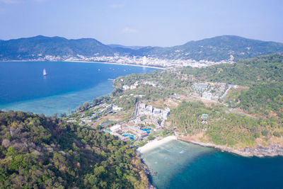 High angle view of sea and mountains against sky