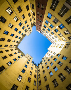 Low angle view of buildings against clear blue sky