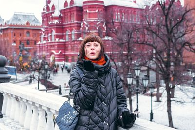 Portrait of woman standing in snow