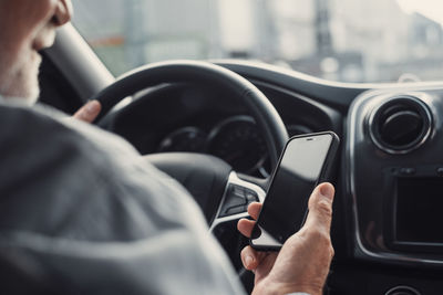 Midsection of man using mobile phone