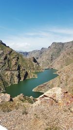 Scenic view of lake and mountains against sky