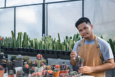 Portrait of young man standing by food