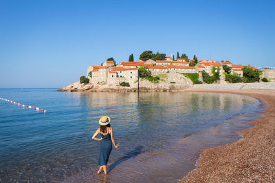 Woman standing on sea