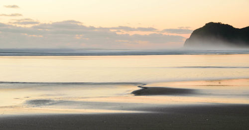 Scenic view of sea against sky at sunset