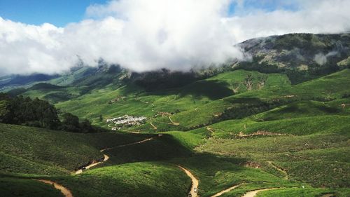 Scenic view of green landscape against sky