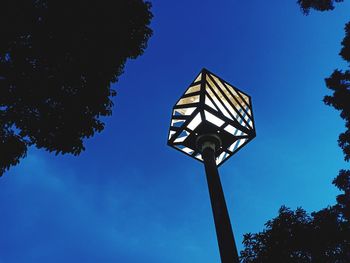 Low angle view of street light against blue sky