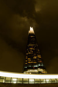 Low angle view of illuminated building against sky at night