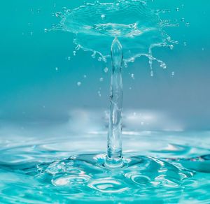 Close-up of water splashing against blue background