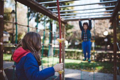 Rear view of woman on swing at playground