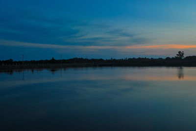 Scenic view of calm lake at sunset