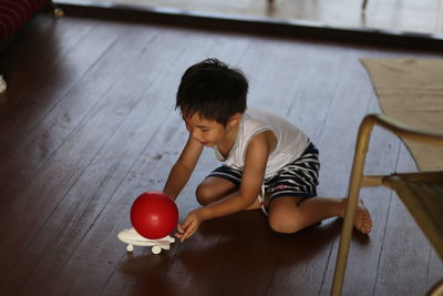 High angle view of boy playing on table at home