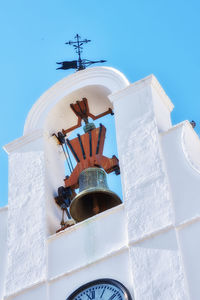 Low angle view of bell tower against sky