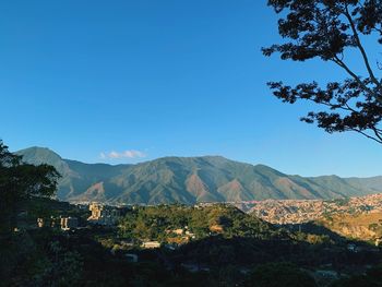 Scenic view of mountains against clear blue sky