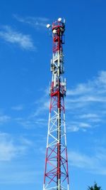 Low angle view of communications tower against blue sky