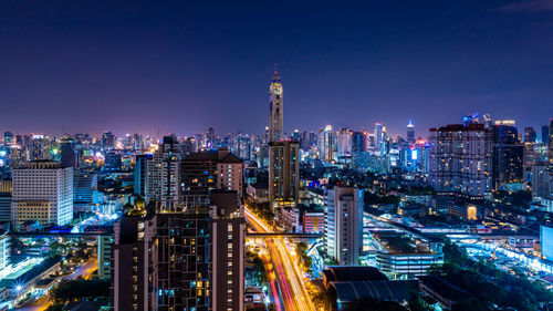 Aerial view of city lit up at night