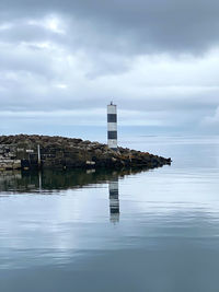 Building by sea against sky