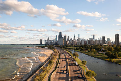 Chicago city skyline aerial centered over traffic along lake shore drive on a sunny day.