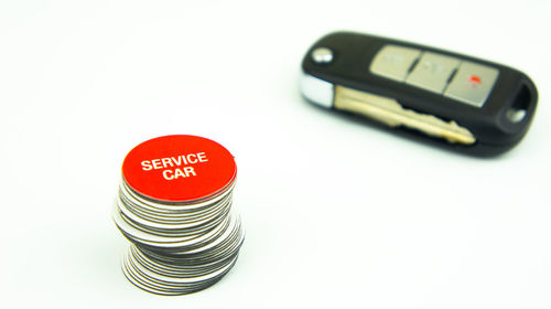 High angle view of telephone on table against white background