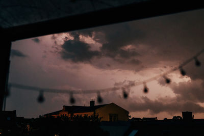 Low angle view of silhouette buildings against sky