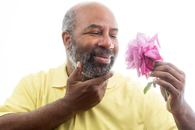 Portrait of man holding flower
