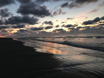 Scenic view of beach against sky during sunset