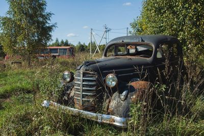 Abandoned car on field