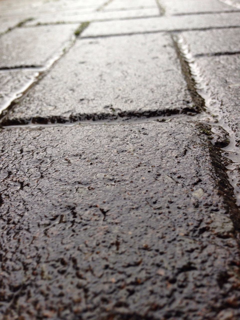 textured, surface level, street, asphalt, high angle view, full frame, pattern, backgrounds, selective focus, close-up, sunlight, road, day, no people, outdoors, shadow, rough, footpath, cobblestone, paving stone