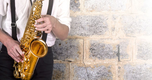 Young man in a white shirt with sax