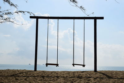 Lifeguard hut on beach against sky