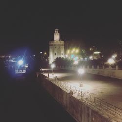 Illuminated city against sky at night