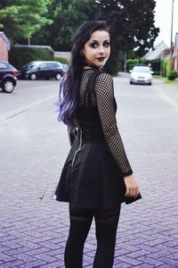 Young woman standing on road