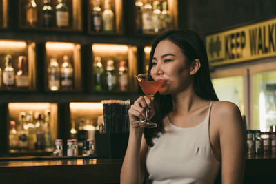 Young woman drinking glass