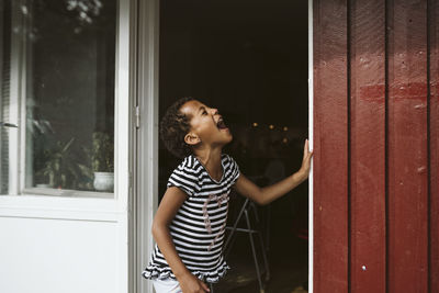 Laughing girl is front of house