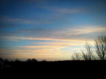 Scenic view of silhouette landscape against sky at sunset