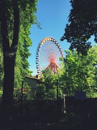 Low angle view of ferris wheel against sky