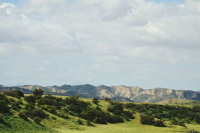 Scenic view of mountains against cloudy sky