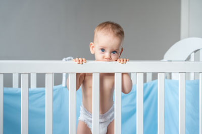 Portrait of cute baby boy sleeping on bed