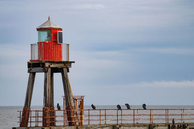 View of harbour light against the sky